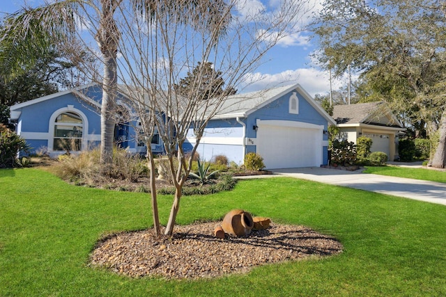 ranch-style house featuring a garage and a front yard