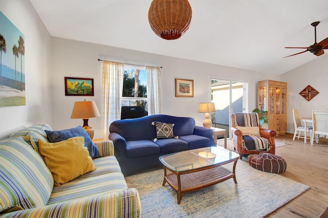 living area featuring plenty of natural light, wood finished floors, ceiling fan, and baseboards