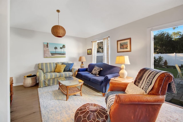 living area featuring light wood-style flooring and baseboards