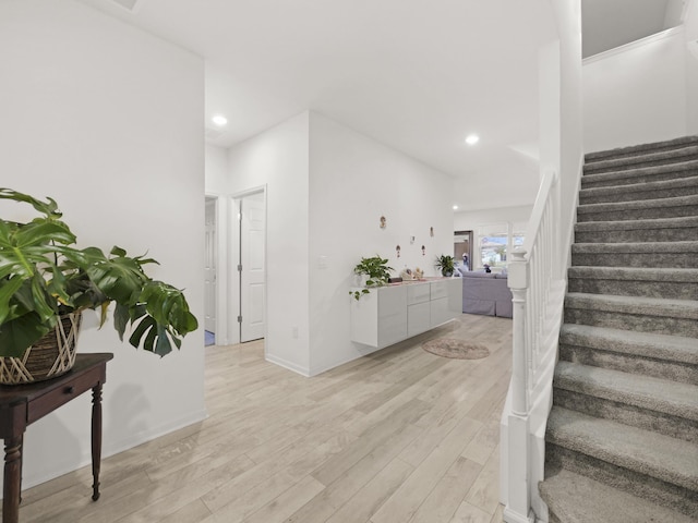 stairway with hardwood / wood-style flooring