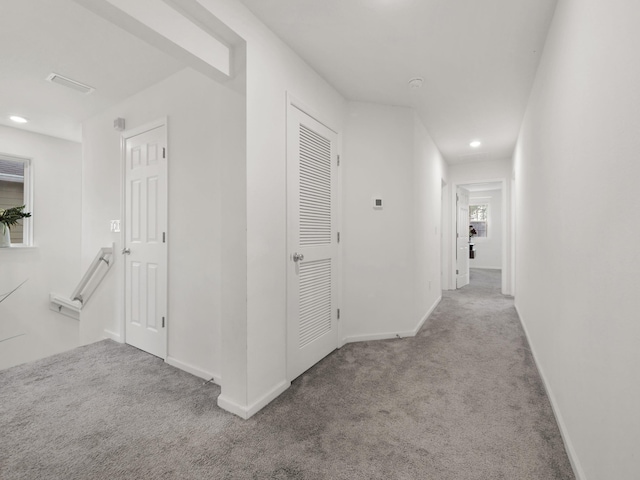 hallway featuring light carpet