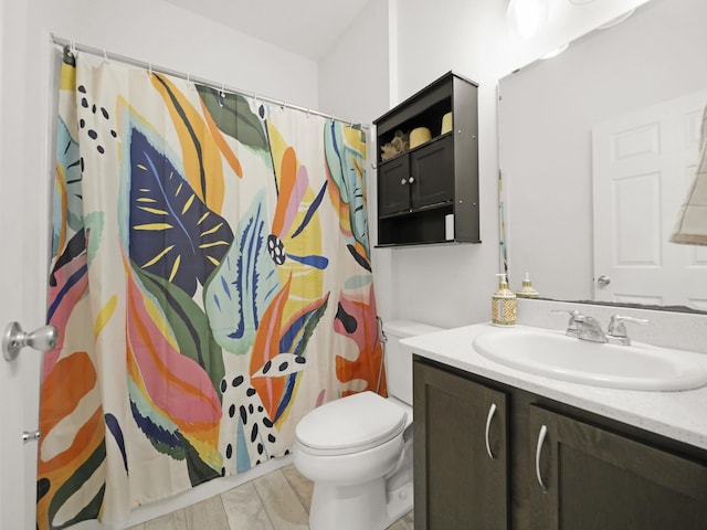 bathroom featuring curtained shower, hardwood / wood-style floors, vanity, and toilet