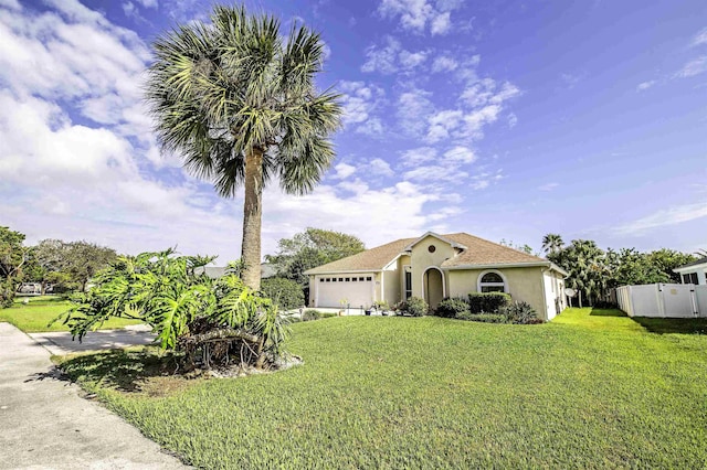 mediterranean / spanish-style house with a front yard and a garage