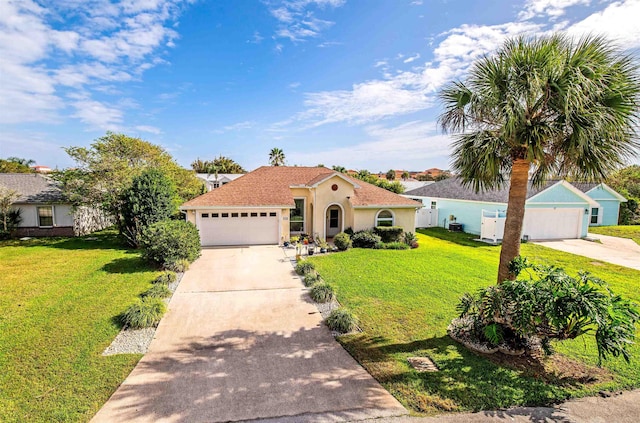 mediterranean / spanish house featuring a garage and a front lawn