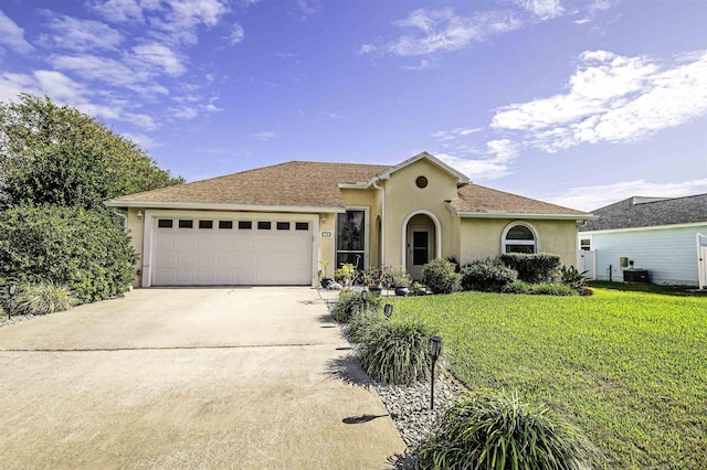 view of front of property featuring a garage and a front lawn