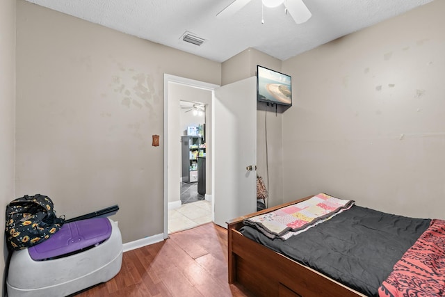 bedroom with ceiling fan and wood-type flooring