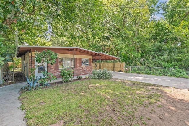 view of front facade featuring a front yard and a carport