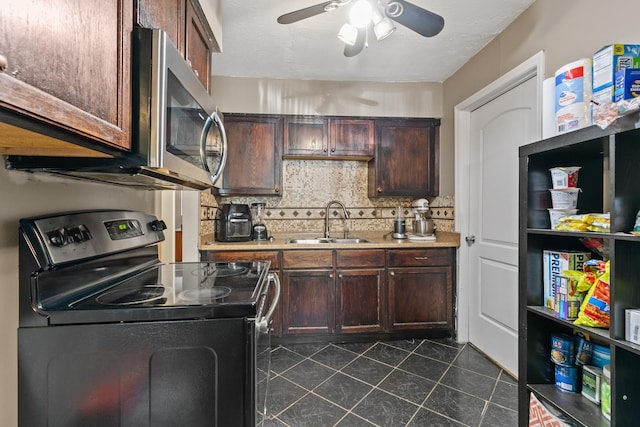 kitchen featuring dark brown cabinetry, electric range, and sink