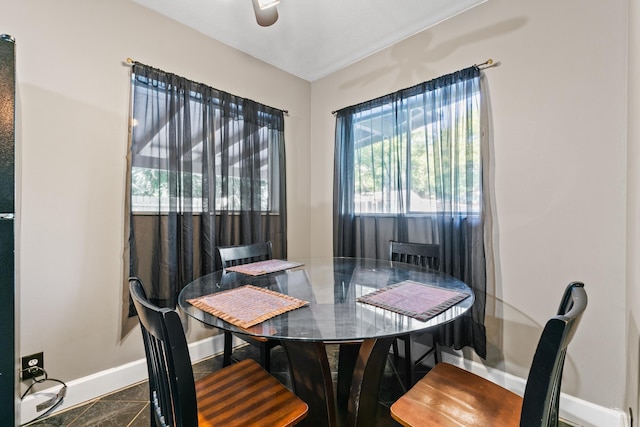 dining area with dark tile patterned flooring