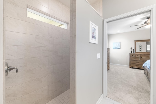 full bathroom featuring a tile shower, ceiling fan, vanity, and baseboards