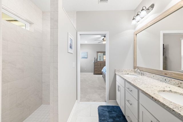 bathroom featuring a sink, connected bathroom, tile patterned flooring, double vanity, and walk in shower