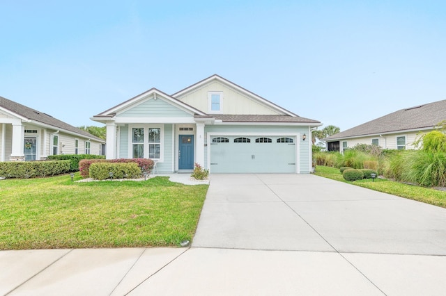 view of front of home featuring a front yard, an attached garage, and driveway