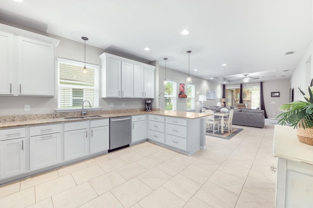 kitchen with visible vents, open floor plan, a peninsula, stainless steel dishwasher, and a sink