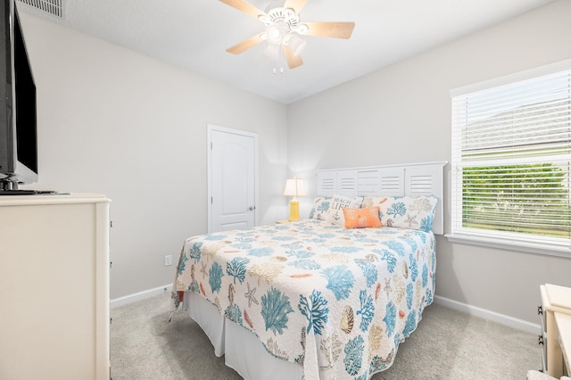 bedroom with visible vents, baseboards, carpet, and a ceiling fan