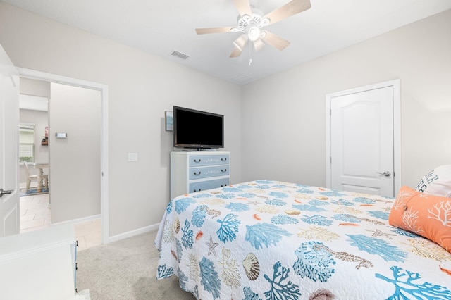 bedroom with visible vents, light carpet, baseboards, and ceiling fan