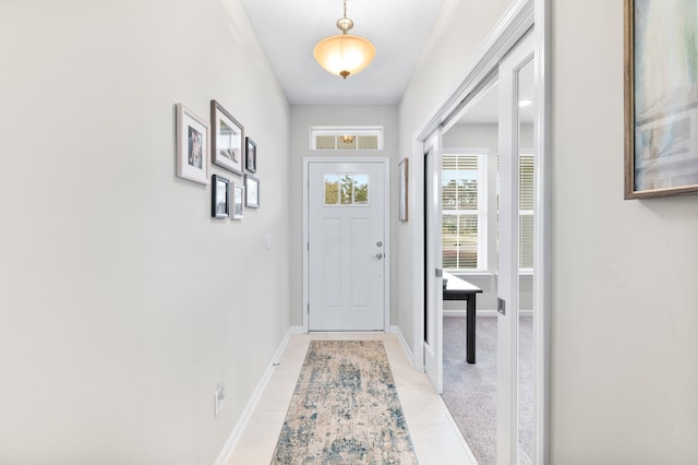 entryway featuring baseboards and light tile patterned flooring