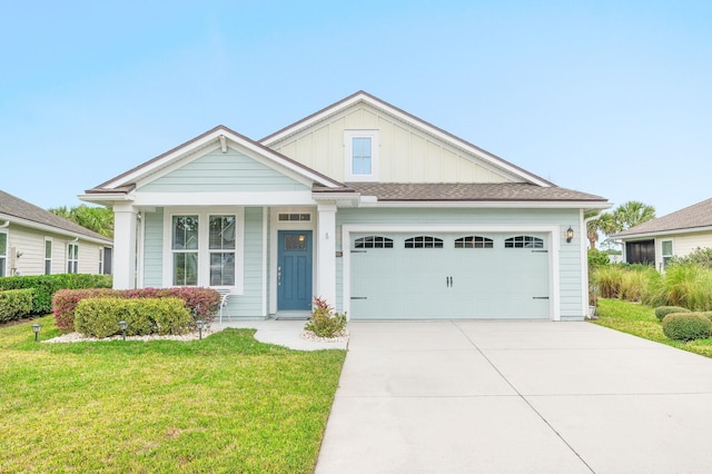 view of front of property with a garage, a front lawn, board and batten siding, and driveway