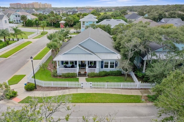 19 Smiling Fish Ln, Palm Coast, FL 32137 - view of front facade featuring a porch, a fenced front yard, and a residential view