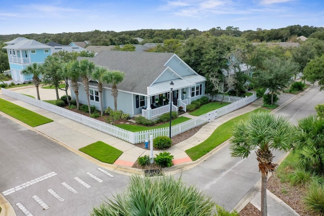 19 Smiling Fish Ln, Palm Coast, FL 32137 - view of front of property with covered porch, a shingled roof, and a fenced front yard