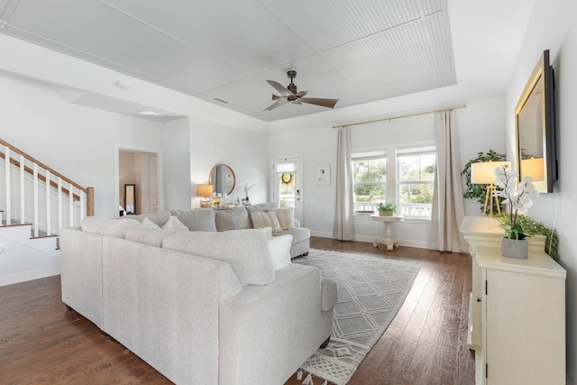 19 Smiling Fish Ln, Palm Coast, FL 32137 - living area with a raised ceiling, ceiling fan, stairs, and dark wood-style floors