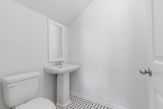 19 Smiling Fish Ln, Palm Coast, FL 32137 - bathroom featuring toilet and baseboards