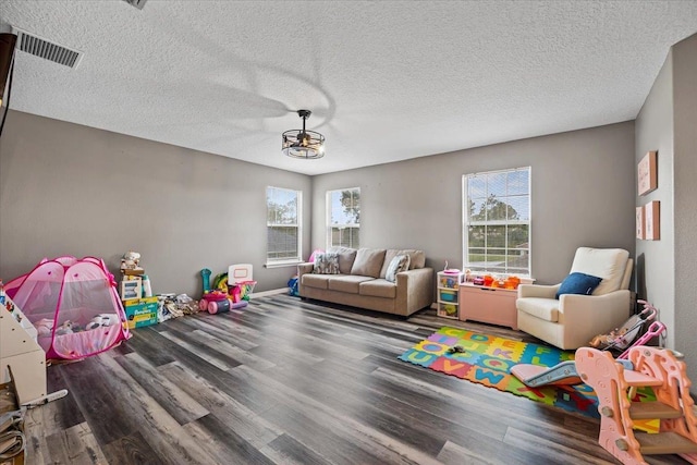 rec room featuring a textured ceiling and hardwood / wood-style flooring