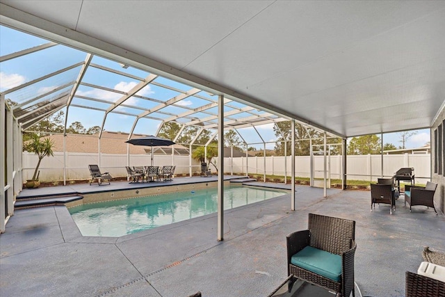 view of swimming pool with a lanai and a patio area