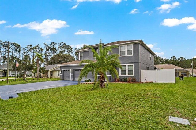 view of front of home featuring a front yard and a garage