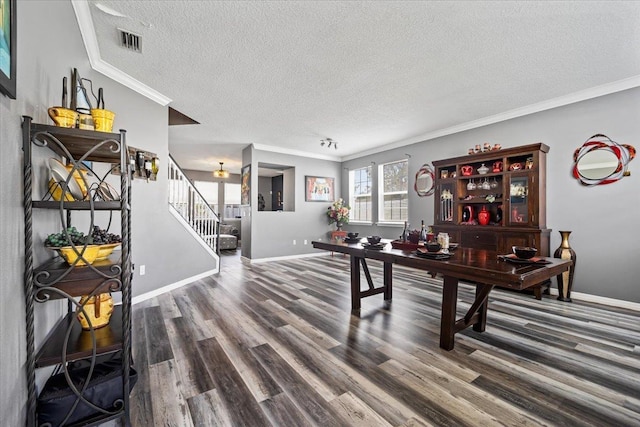 interior space with hardwood / wood-style floors, a textured ceiling, and ornamental molding