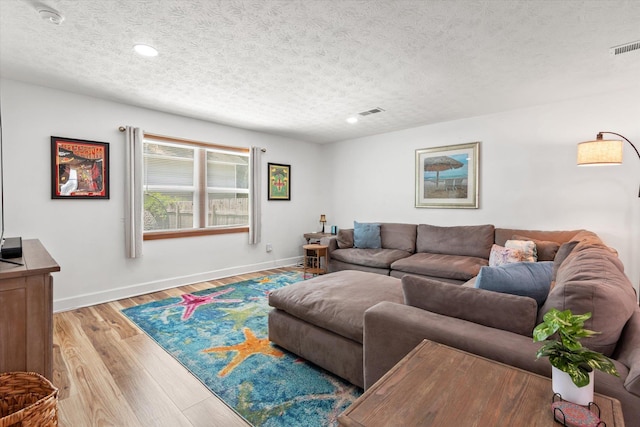 13 Douglas Ave, Saint Augustine, FL 32084 - living room featuring a textured ceiling, baseboards, light wood-style floors, and recessed lighting