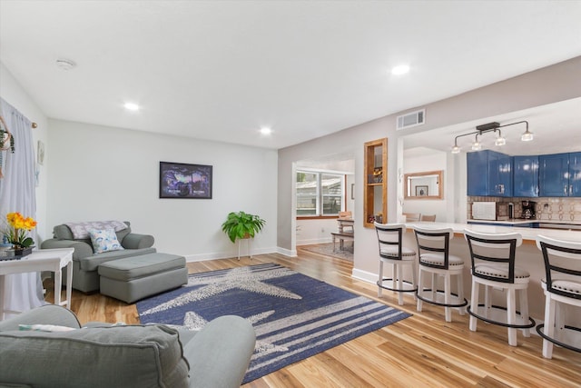 13 Douglas Ave, Saint Augustine, FL 32084 - living room featuring light wood-type flooring, recessed lighting, baseboards, and rail lighting