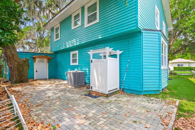 13 Douglas Ave, Saint Augustine, FL 32084 - rear view of property with central AC and a patio