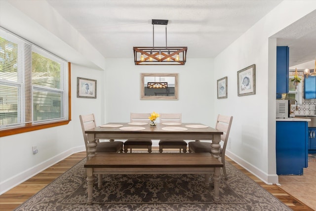 13 Douglas Ave, Saint Augustine, FL 32084 - dining space with wood finished floors, baseboards, and a chandelier