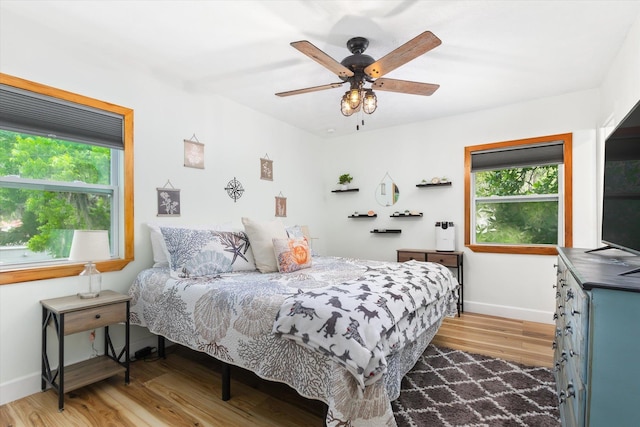 13 Douglas Ave, Saint Augustine, FL 32084 - bedroom with light wood finished floors, multiple windows, baseboards, and a ceiling fan