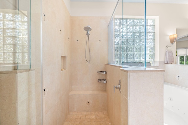 bathroom with a walk in shower and a tub with jets