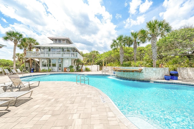 community pool featuring a patio area and fence