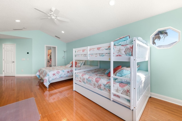 bedroom featuring baseboards, recessed lighting, wood finished floors, and lofted ceiling