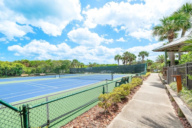 view of tennis court featuring fence