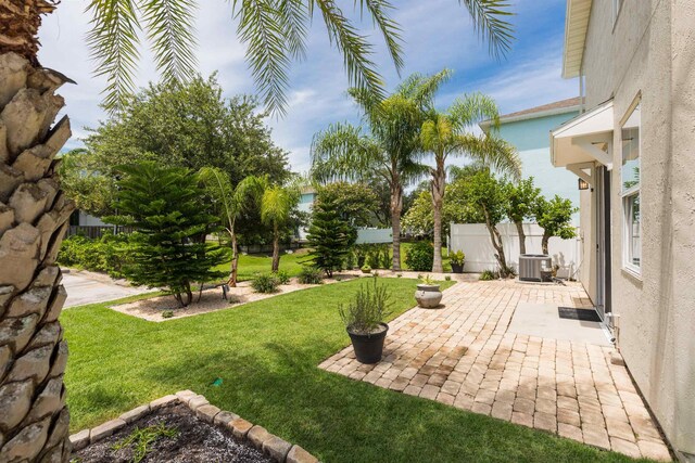 view of yard featuring cooling unit and a patio area