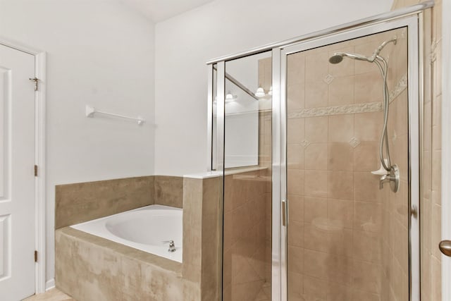 bathroom featuring separate shower and tub