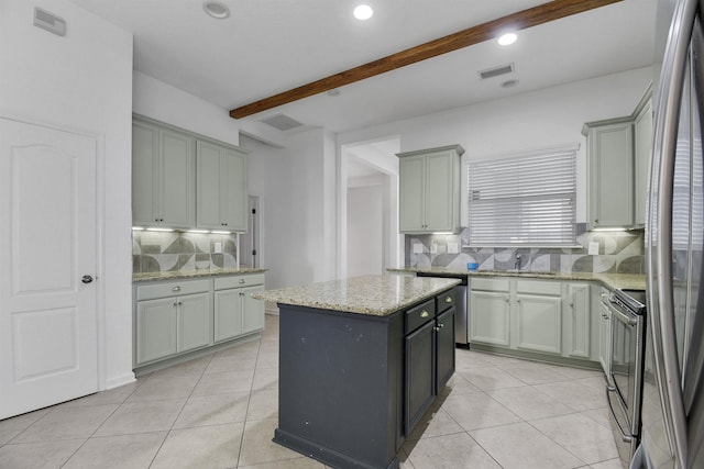 kitchen featuring stainless steel electric stove, a kitchen island, gray cabinetry, and beam ceiling