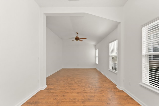 empty room with hardwood / wood-style floors, ceiling fan, and lofted ceiling