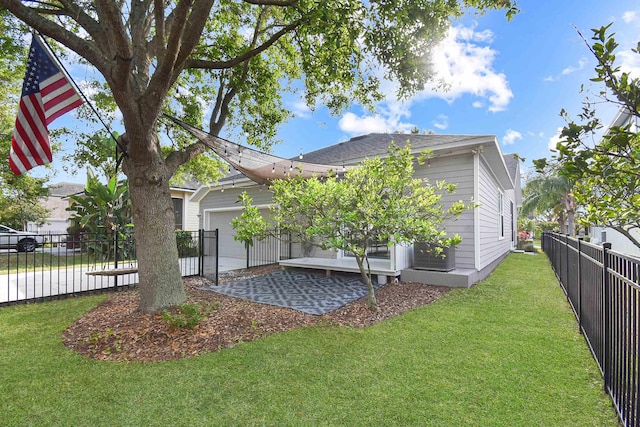 exterior space with a garage and a lawn