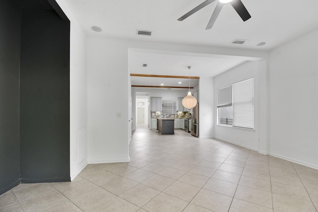 unfurnished room with ceiling fan and light tile patterned flooring