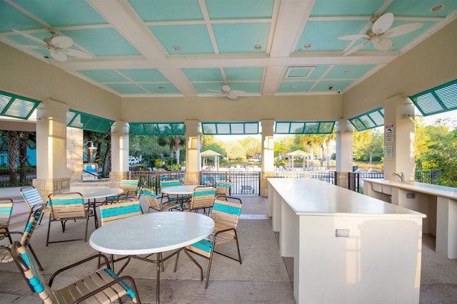 view of patio / terrace featuring an outdoor bar and ceiling fan