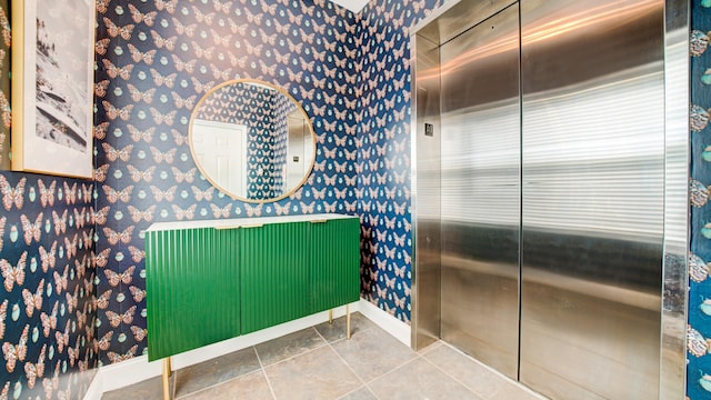 bathroom with baseboards and wallpapered walls