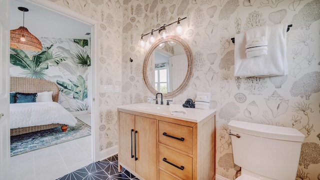 bathroom featuring toilet, ensuite bathroom, vanity, tile patterned flooring, and wallpapered walls