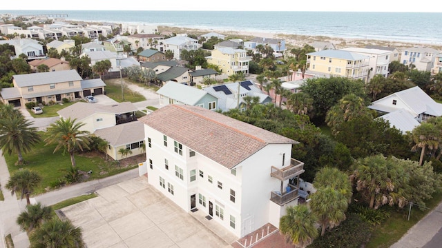 bird's eye view featuring a beach view, a water view, and a residential view