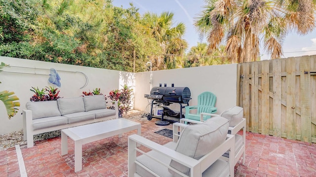 view of patio with outdoor lounge area, a fenced backyard, and grilling area