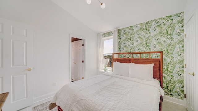 bedroom with wallpapered walls, baseboards, and vaulted ceiling